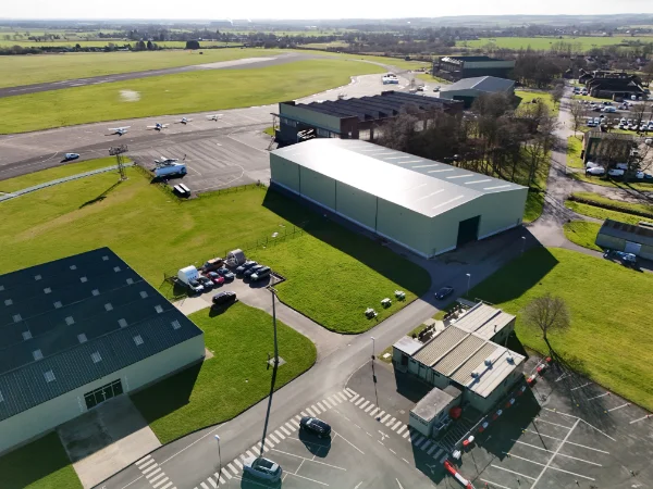 Aerial photograph of business units on an industrial estate with the sea in the background, taken on an overcast day.